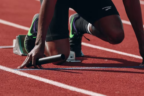 Runner at starting blocks on running track